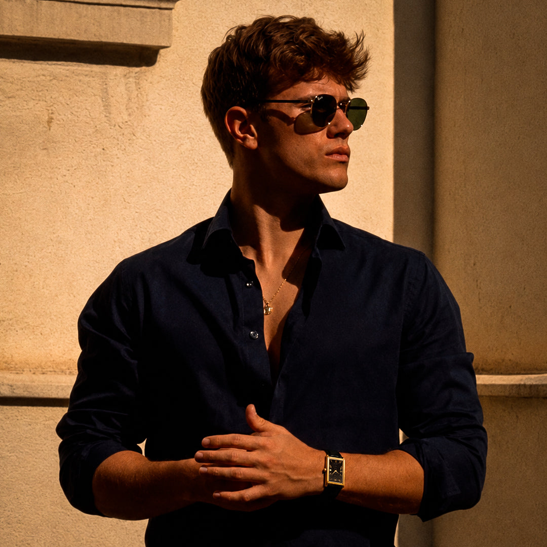 A man on the Amalfi Coast wearing the 1962 gold tank watch in golden light