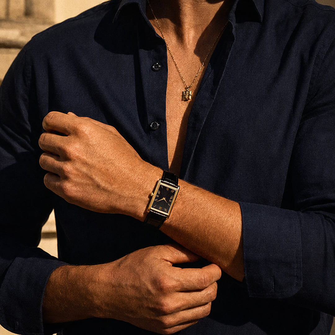 The 1962 gold tank watch worn with an open navy shirt and a gold chain