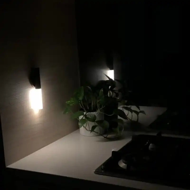 Rechargeable sensor wall light — two lights glowing on a kitchen backsplash at night