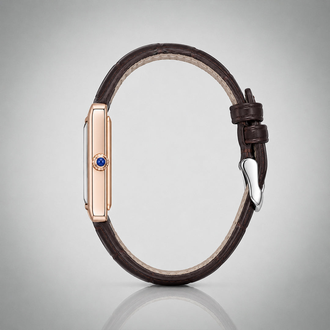 Side profile of the 1927 gold tank case with blue cabochon crown and brown leather strap
