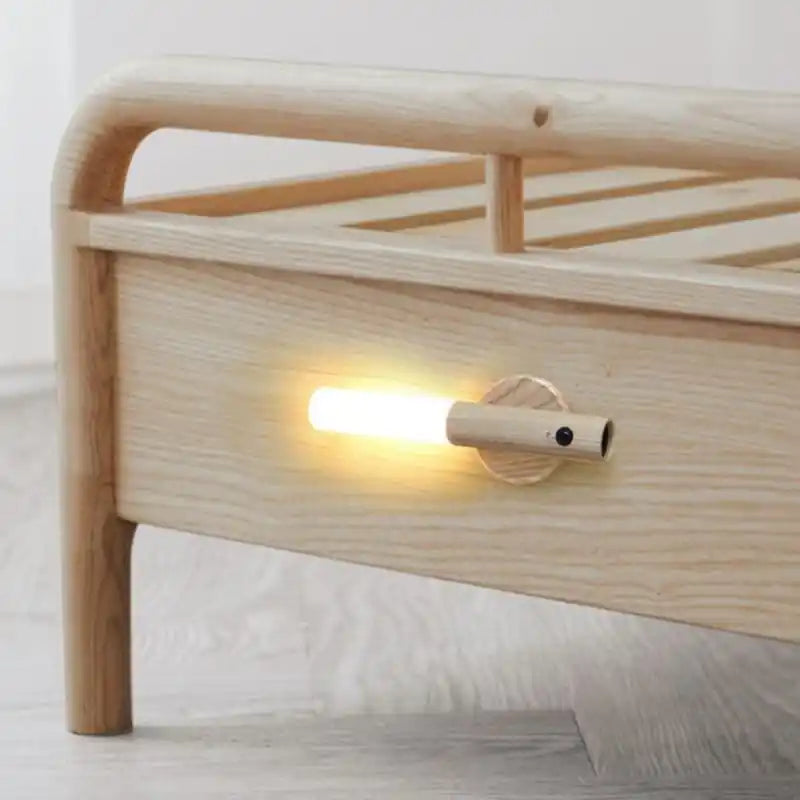Rechargeable sensor wall light — attached magnetically to a timber bed frame