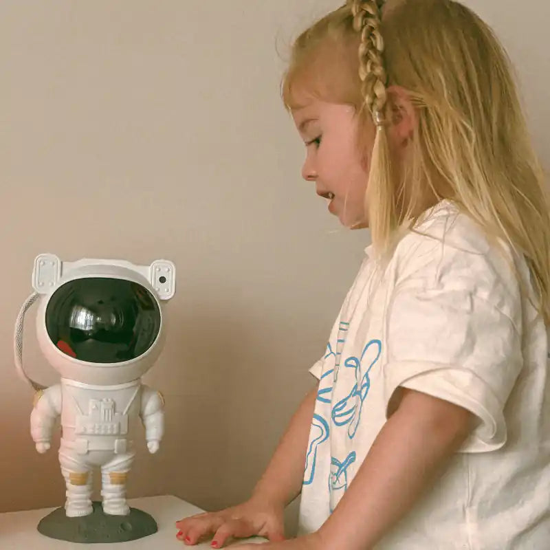 Astronaut galaxy projector — child holding the astronaut projector