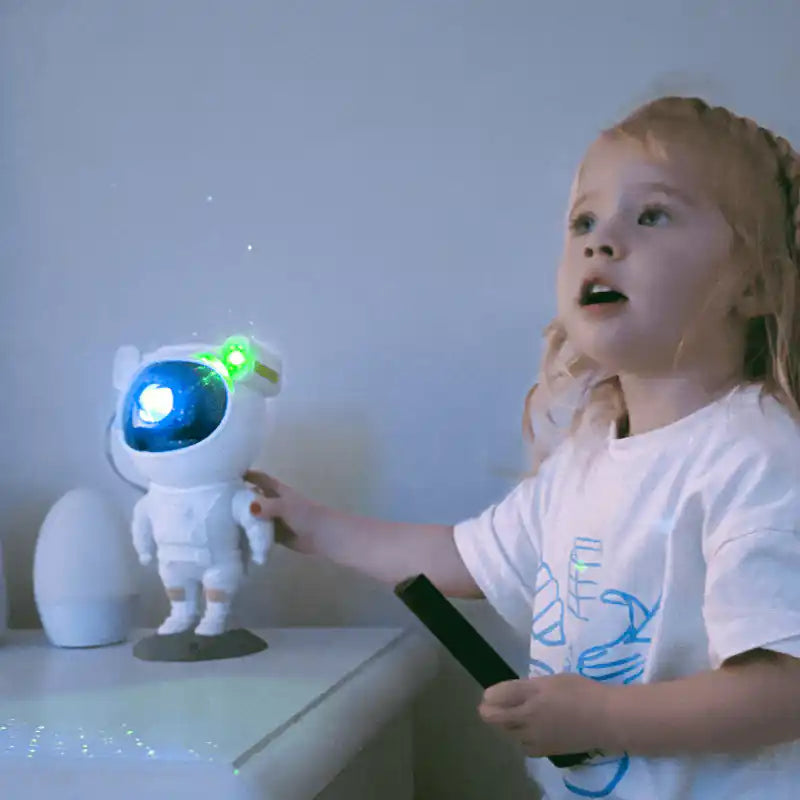 Astronaut galaxy projector — child enjoying the projector's star light show