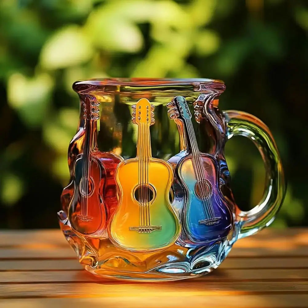 Colorful glass mug with guitar design on a wooden surface with blurred greenery in the background