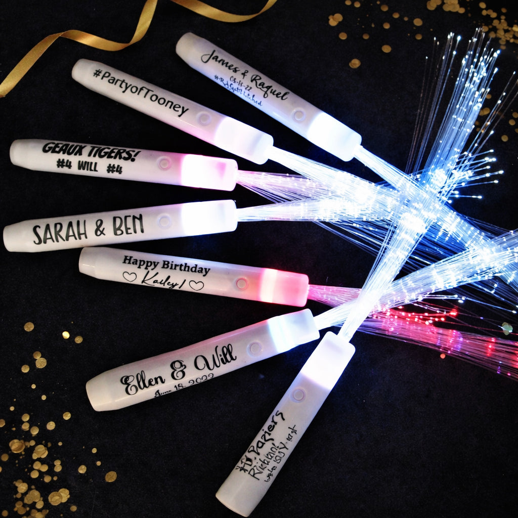 Fiber optic sticks with personalized names on a dark background